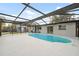 Screened-in pool in backyard of home with lush surroundings at 8256 Lark St, Seminole, FL 33777