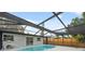 Backyard with a screened-in pool and an enclosed fence at 8256 Lark St, Seminole, FL 33777