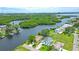 Aerial view showcasing the waterfront home, lush greenery, and scenic surroundings at 8759 Orient Ne Way, St Petersburg, FL 33702
