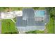 Aerial view of home with roof and large pool with lanai and surrounding yard at 8759 Orient Ne Way, St Petersburg, FL 33702