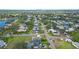 Aerial view of neighborhood with winding canals, mature trees, and bay access at 8759 Orient Ne Way, St Petersburg, FL 33702