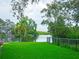 Serene backyard with lush green lawn and waterfront views, perfect for enjoying nature and outdoor activities at 8759 Orient Ne Way, St Petersburg, FL 33702