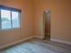Bright bedroom featuring a large window letting in natural light, complemented by modern flooring and neutral wall colors at 8759 Orient Ne Way, St Petersburg, FL 33702