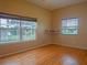 Bright bedroom features hardwood floors and multiple windows offering lots of natural light at 8759 Orient Ne Way, St Petersburg, FL 33702