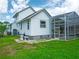 White two-story home with screened pool enclosure and well-maintained backyard at 8759 Orient Ne Way, St Petersburg, FL 33702