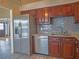 Kitchen boasts stainless steel refrigerator, stone countertops, and stylish tile backsplash at 8759 Orient Ne Way, St Petersburg, FL 33702