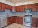 Well-equipped kitchen featuring stainless steel appliances, granite countertops, and wooden cabinets at 8759 Orient Ne Way, St Petersburg, FL 33702