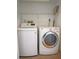Efficient laundry room with modern LG washer and dryer, featuring convenient overhead shelving for storage at 8759 Orient Ne Way, St Petersburg, FL 33702