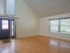 Inviting living room with hardwood floors, large windows, and a welcoming entryway at 8759 Orient Ne Way, St Petersburg, FL 33702
