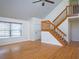 Bright living area featuring hardwood floors, a staircase, and ample natural light at 8759 Orient Ne Way, St Petersburg, FL 33702