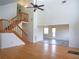 Open-concept living area with hardwood floors, high ceilings, and staircase at 8759 Orient Ne Way, St Petersburg, FL 33702