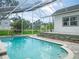 Refreshing screened-in pool area with brick accents, perfect for outdoor relaxation and entertaining at 8759 Orient Ne Way, St Petersburg, FL 33702