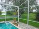Beautiful backyard with a sparkling pool, screened enclosure, and serene views, perfect for relaxing and entertaining at 8759 Orient Ne Way, St Petersburg, FL 33702