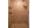 Tiled shower with mosaic floor, shower head, and built-in shelving at 8759 Orient Ne Way, St Petersburg, FL 33702