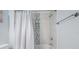 Bright bathroom featuring a tiled shower with a tub and modern fixtures at 12351 Cloverstone Dr, Tampa, FL 33624