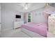 Bright bedroom featuring a ceiling fan, window, and pink bed with storage at 12351 Cloverstone Dr, Tampa, FL 33624