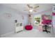 Bright bedroom featuring marble floors, a ceiling fan, and pink decorations at 12351 Cloverstone Dr, Tampa, FL 33624