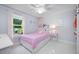 Charming bedroom featuring a pink bed with a window view at 12351 Cloverstone Dr, Tampa, FL 33624