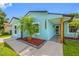 Charming single Gathering home with a well-manicured front yard and blue paint at 12351 Cloverstone Dr, Tampa, FL 33624