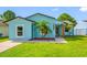 Close up exterior shot of the single-story home with its bright blue exterior at 12351 Cloverstone Dr, Tampa, FL 33624