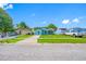 Street view of a charming blue home with a well-maintained front lawn at 12351 Cloverstone Dr, Tampa, FL 33624