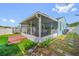 Exterior view of the home featuring a screened patio and spacious backyard at 12351 Cloverstone Dr, Tampa, FL 33624