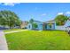 Charming single-story home with a bright blue exterior and lush green lawn at 12351 Cloverstone Dr, Tampa, FL 33624
