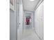 Bright hallway leading to a bedroom and bathroom with closet space at 12351 Cloverstone Dr, Tampa, FL 33624