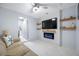 Modern living room features a fireplace, television, and open doorway at 12351 Cloverstone Dr, Tampa, FL 33624