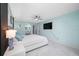 Spacious main bedroom featuring a ceiling fan, TV, and entry to main bathroom at 12351 Cloverstone Dr, Tampa, FL 33624