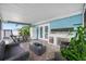 Cozy screened patio offering a dining area, comfortable lounge, and tiled floors at 12351 Cloverstone Dr, Tampa, FL 33624