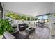 Inviting screened patio featuring comfortable seating, a dining set, and tile flooring at 12351 Cloverstone Dr, Tampa, FL 33624