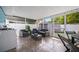 Relaxing screened patio with stylish furniture, outdoor kitchen, and tile flooring at 12351 Cloverstone Dr, Tampa, FL 33624