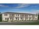 New townhouse exteriors feature neutral paint, symmetrical windows, and simple landscaping at 14044 Textile Run, Parrish, FL 34219