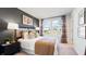 Inviting bedroom featuring modern decor, a large window, and neutral tones at 14048 Textile Run, Parrish, FL 34219