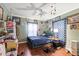 Bedroom with a ceiling fan, blue accents, and multiple decorative touches creating a cozy space at 1453 Belleair Rd, Clearwater, FL 33756