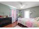 Bedroom with hardwood floors, natural lighting, closet, and comfortable bed at 1453 Belleair Rd, Clearwater, FL 33756