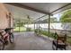 Large screened patio, featuring a ceiling fan, and plenty of room for outdoor living and recreation at 1453 Belleair Rd, Clearwater, FL 33756