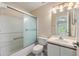 Bathroom features a shower-tub combo with sliding glass doors, a toilet, and a vanity sink with ample lighting at 14625 Par Club Cir # 14625, Tampa, FL 33618