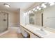 Bathroom featuring double sinks, a soaking tub, walk-in shower, and ample countertop space at 14625 Par Club Cir # 14625, Tampa, FL 33618