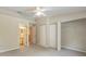 Cozy bedroom featuring neutral carpeting, a ceiling fan, and ample closet space for storage at 14625 Par Club Cir # 14625, Tampa, FL 33618