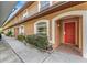 Inviting condo exterior with a red front door, manicured landscaping, and a well-lit walkway at 14625 Par Club Cir # 14625, Tampa, FL 33618
