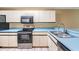 Kitchen featuring stainless steel appliances, bright countertops, and white cabinetry at 14625 Par Club Cir # 14625, Tampa, FL 33618