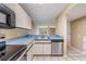 Functional kitchen with stainless steel appliances, white cabinetry, and light blue countertops at 14625 Par Club Cir # 14625, Tampa, FL 33618