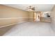 Bright living room featuring neutral carpeting and a ceiling fan; open to kitchen at 14625 Par Club Cir # 14625, Tampa, FL 33618