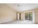 Bright main bedroom featuring a vaulted ceiling and balcony access with neighborhood views at 14625 Par Club Cir # 14625, Tampa, FL 33618