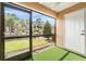 Covered screened patio with turf and peaceful views of canal, greenery, and neighboring townhomes at 14625 Par Club Cir # 14625, Tampa, FL 33618