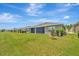 Spacious backyard with lush green lawn, well-maintained landscaping, and serene views at 18164 Turning Leaf Cir, Land O Lakes, FL 34638