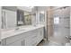 Modern bathroom featuring a double sink vanity, quartz countertops, and a glass-enclosed shower at 18164 Turning Leaf Cir, Land O Lakes, FL 34638