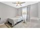 Comfortable bedroom with ceiling fan, soft natural light, and inviting decor for a relaxing atmosphere at 18164 Turning Leaf Cir, Land O Lakes, FL 34638